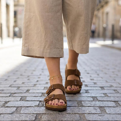 CUSHIONAIRE Lane Cork Footbed Sandals for Women – Comfortable Double Buckle Slip-On with Genuine Suede Footbed & Arch Support Slides for Women Footwear, BROWN 9W
